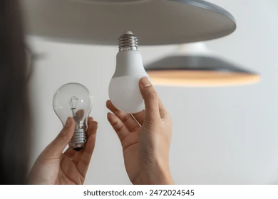 young-woman-changing-light-bulbs-260nw-2472024545